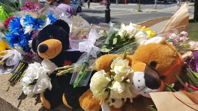 Des fleurs ont été déposées au poste de police de Fredericton pour rendre hommage aux deux policiers morts, vendredi. Des fleurs ont été déposées au poste de police de Fredericton pour rendre hommage aux deux policiers morts, vendredi.