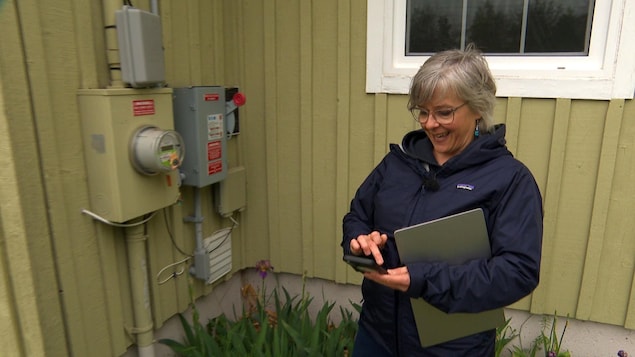 Francine Hébert avec un ordinateur portable et une calculatrice en main. 