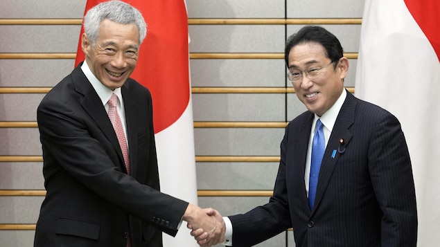 Singapore's Prime Minister Lee Hsien Loong, left, shakes hands with Japan's Prime Minister Fumio Kishida at the start of their meeting at the Prime Minister's official residence in Tokyo, May 26, 2022. Earlier in the day, Singapore's Prime Minister Lee Hsien Loong participated to the 'Future of Asia' International Conference. (Franck Robichon/Pool Photo via AP)