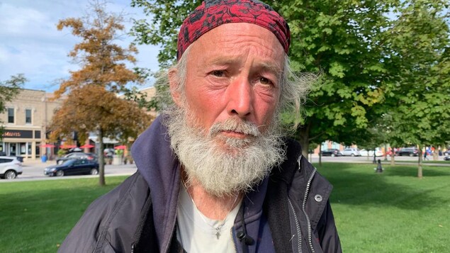 Portrait of a bearded man wearing a bandana. He stares intently into the camera.