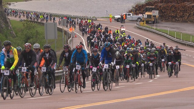 Des centaines de cyclistes montent une cote. Des centaines de cyclistes montent une cote.