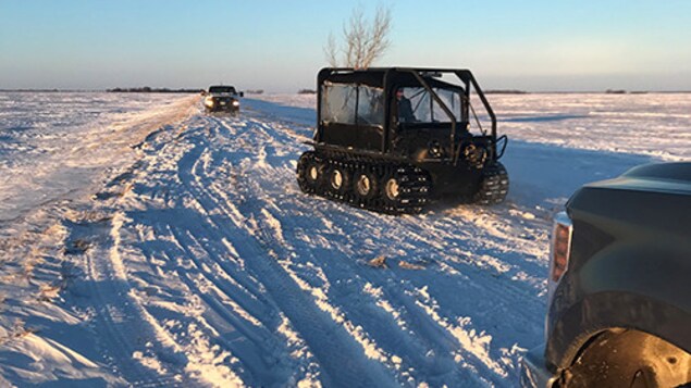 Des véhicules de la GRC dans un champ couvert de neige au Manitoba, à la frontière entre le Canada et les États-Unis.