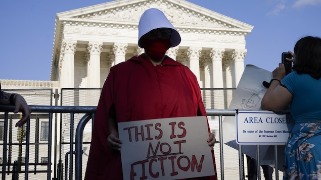 An abortion-rights protester dressed in a costume from the "Handmaid's Tale," protests outside of the Supreme Court in Washington, Friday, June 24, 2022. The Supreme Court has ended constitutional protections for abortion that had been in place nearly 50 years, a decision by its conservative majority to overturn the court's landmark abortion cases.Â (AP Photo/Jacquelyn Martin)
