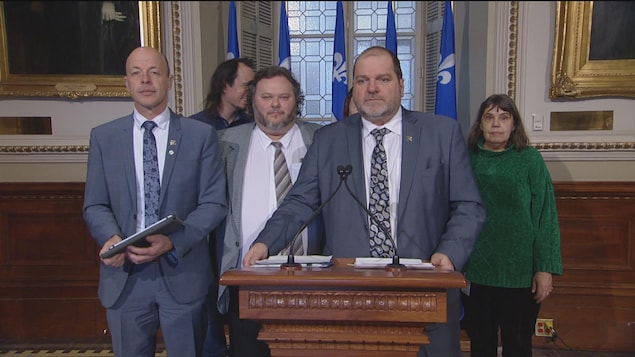Harold Lebel, entouré de Joël Arseneau et de représentants du groupe L'A-DROIT.