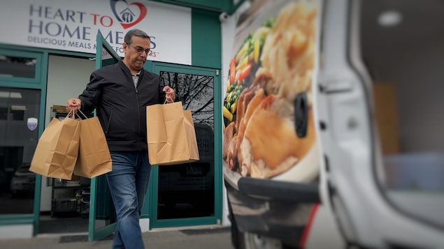 Un homme avec des sacs dans les mains.