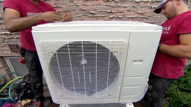 A new heat pump is installed at a home to replace both an old air conditioner and a natural gas furnace. (Spencer Gallichan-Lowe/CBC)