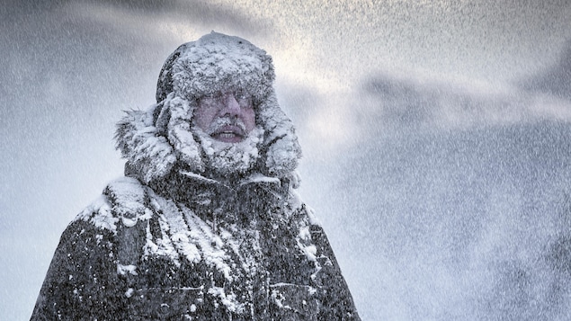 Un homme se tient dans le froid intense.