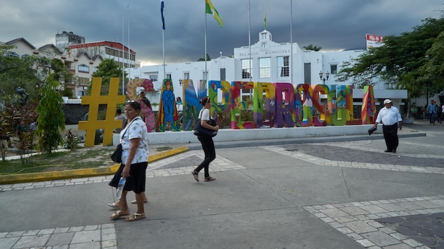 Des gens marchent dans la rue à San Pedro Sula, au Honduras. Des gens marchent dans la rue à San Pedro Sula, au Honduras.