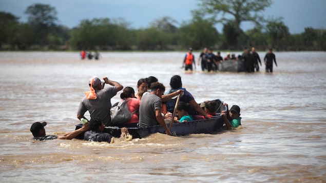 Personas en un bote en una zona inundada tras el paso del huracán Eta.