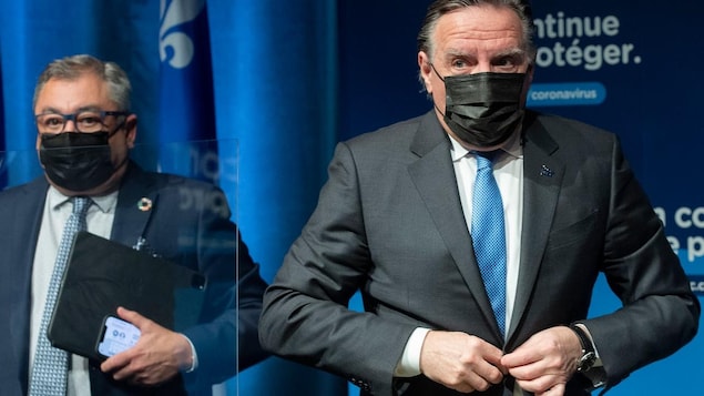 Horacio Arruda et François Legault, masqués, après une conférence de presse.