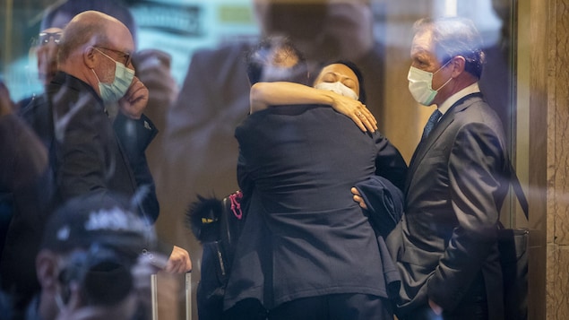 Meng Wanzhou hugs her lawyers.