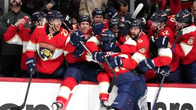 Florida Panthers forward Matthew Tkachuk celebrates with teammates after scoring the winning goal in Game 4 against the Carolina Hurricanes on Wednesday. Florida is headed to its second Stanley Cup final in franchise history. (Lynne Sladky/The Associated Press)