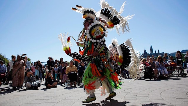 A traditional dance is performed on National Indigenous Peoples Day behind the Canadian Museum of History in Gatineau, Que., on June 21, 2018. 