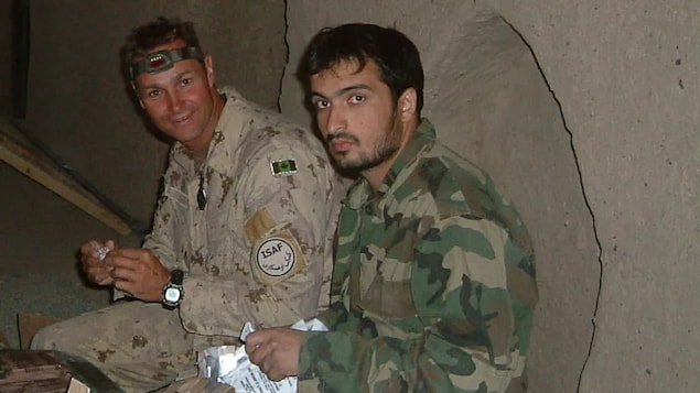 'Hearing about his situation right now actually gives me palpitations,' says retired master warrant officer Guevens Guimont, left, seen here in Afghanistan with interpreter Mohammed Nabi Wardak, right, who is now homeless and jobless in Athens. Wardak fled Afghanistan years ago because of death threats from the Taliban. 