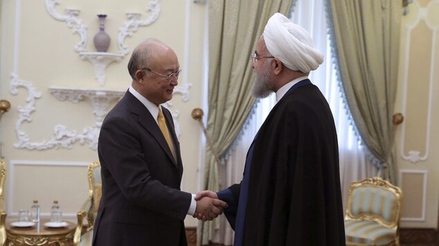 Yukiya Amano serre la main de Hassan Rohani.