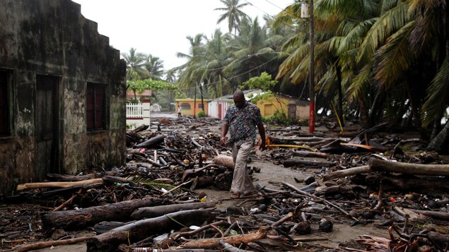 Un homme marche parmi les débris, sur la côte nord de la République dominicaine. Un homme marche parmi les débris, sur la côte nord de la République dominicaine.
