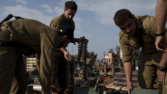 Israeli soldiers store ammunition at a staging area.