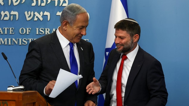 Benyamin Netanyahu serre la main de Bezalel Smotrich lors d'une conférence de presse.