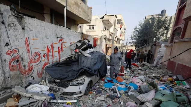 Palestinians inspect the site of an Israeli strike on a house, in Rafah in the southern Gaza Strip on Feb. 27. The death toll in Gaza since Oct. 7 passed another grim milestone, Palestinian health officials said Thursday. 