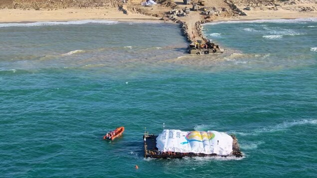 An aerial view from March 15 shows a barge loaded with food operated by the non-profit group World Central Kitchen arriving off the coast of Gaza. Palestinians in the region are at risk of famine after five months of Israel's military campaign.