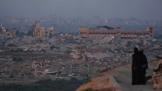 Palestinians look at the destruction caused by the Israeli air and ground offensive, in central Gaza Strip on Sept. 4. 