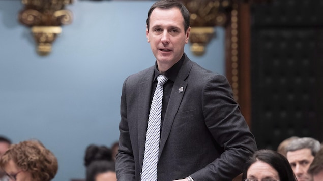 Jean-François Roberge, documents en main, est debout à l'Assemblée nationale.