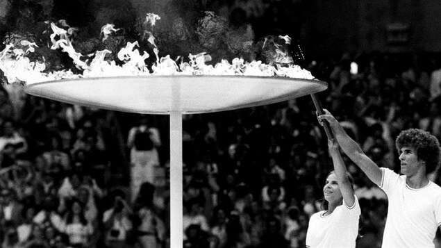 Stéphane Préfontaine et Sandra Henderson allument la vasque olympique au Stade lors de la cérémonie d'ouverture le 17 juillet 1976. Stéphane Préfontaine et Sandra Henderson allument la vasque olympique au Stade lors de la cérémonie d'ouverture le 17 juillet 1976.