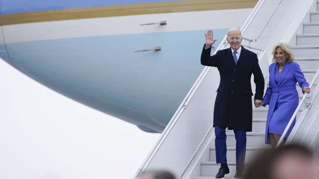 U.S. President Joe Biden waves as he and First Lady Jill Biden exit Air Force One after arriving at Ottawa International Airport on Thursday in Ottawa.