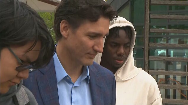 Trudeau kasama ang isang lalaki at babae na estudyante.