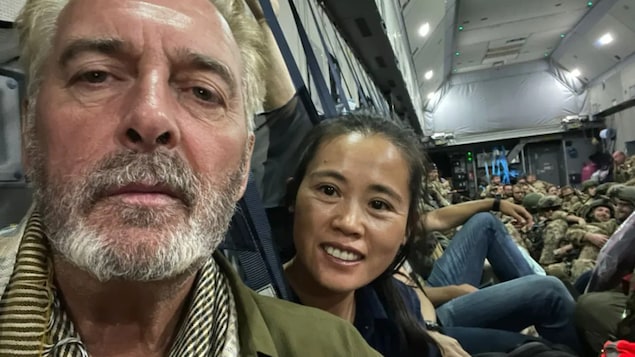 Selfie of David Lavery and Junping Zhang-Lavery sitting in German airlift after leaving Kabul Airport.