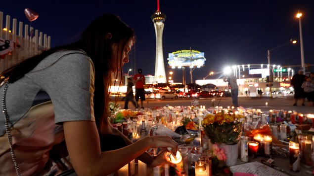 Dashenka Giraldo, une résidente de Las Vegas, allume une bougie à la mémoire des 59 victimes qui ont péri lors de la tuerie survenue dimanche.