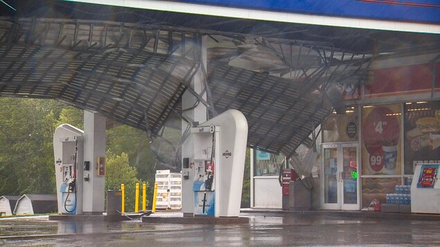 The Roof Of A Gas Station Flying Off.