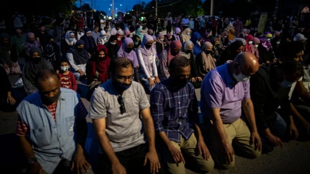 People pray following a vigil attended by thousands in London, Ont., for a family of four killed in an attack police say was motivated by anti-Muslim hate.
