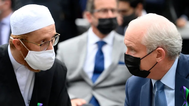 Conservative Leader Erin O'Toole, right, speaks with London Muslim Mosque imam Abd Alfatah Twakkal at a vigil for the victims of the deadly vehicle attack on five members of the Canadian Muslim community in London, Ont., on Tuesday, June 8, 2021. The party has little diverse representation in its Commons caucus after Monday's vote.
