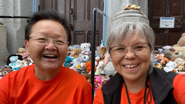 Residential school survivor Lou-ann Neel, right, with her sister Joani Glendale on the steps of a Catholic church in Victoria. Neel has found homes with primarily First Nations families for an estimated 200 stuffed animals and 100 pairs of children's shoes left at a vigil to honour the children who never came home from a residential school in Kamloops, B.C.