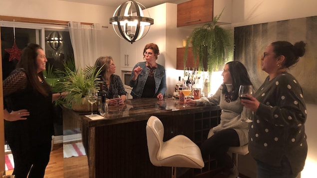 Marilyn Nadeau, Julie Pressé, Geneviève Dubois, Alexandra Labbé et Stéphanie Lacoste discutent autour d'un îlot de cuisine.
