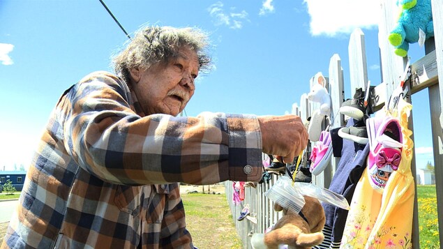 Tabi McKenzie devant la clôture du site Innu Nikamu à Mani-utenam.