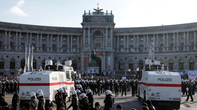 Des policiers se déploient devant des manifestants. Des policiers se déploient devant des manifestants.