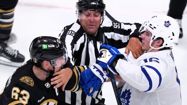NHL linesman Jonny Murray tries to separate Brad Marchand and Mitch Marner during Game 5 of the NHL playoff series between the Bruins and the Leafs Tuesday in Boston. Cable TV's last line of defence against cord cutting has long been the audience for live sports, but a bid by streaming companies to air sports on their platforms could change that. 