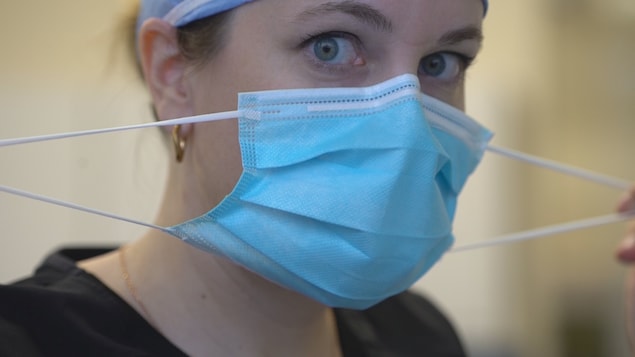 La Dre Marie Gosselin enlève son masque après une intervention sur une patiente.