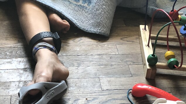 Marisol est assise sur le sol dans un refuge pour migrants illégaux à El Paso, au Texas. Il y a des jouets d'enfant autour d'elle.