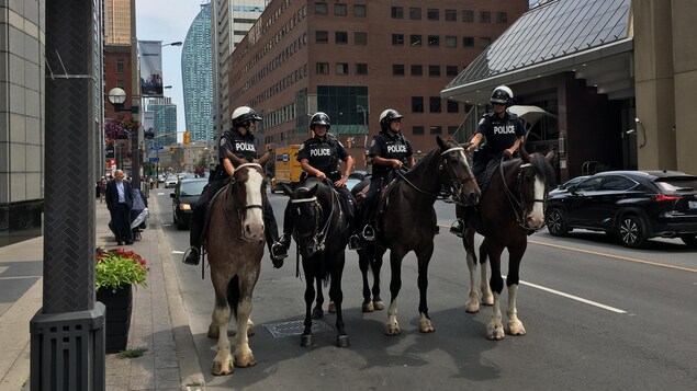 Photo de policiers sur des chevaux dans la rue. Photo de policiers sur des chevaux dans la rue.