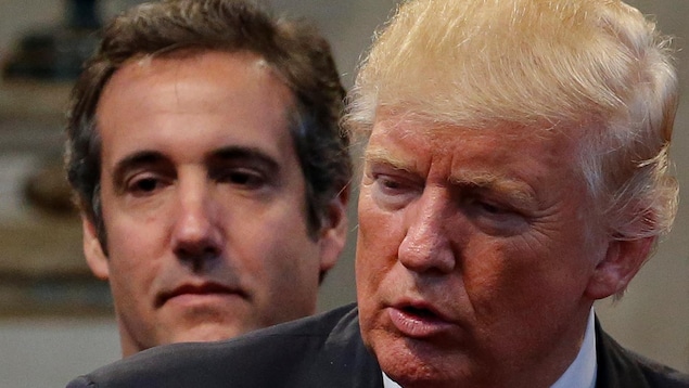 Michael Cohen, left, Donald Trump's former personal lawyer, is shown with Trump in Cleveland Heights, Ohio, during the presidential election campaign on Sept. 21, 2016. Cohen is expected to testify for the prosecution at the former U.S. president's criminal trial in New York on Monday. 