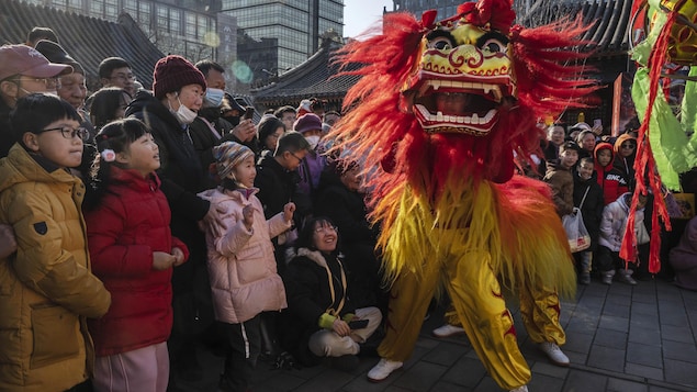 Les gens regardent une danse traditionnelle du lion.