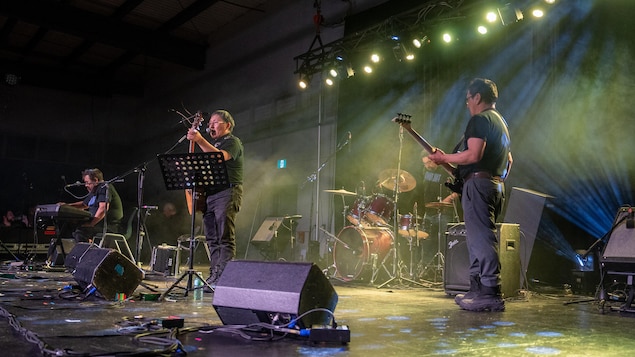 Des musiciens sur une scène jouent pour le public, en mars 2025.