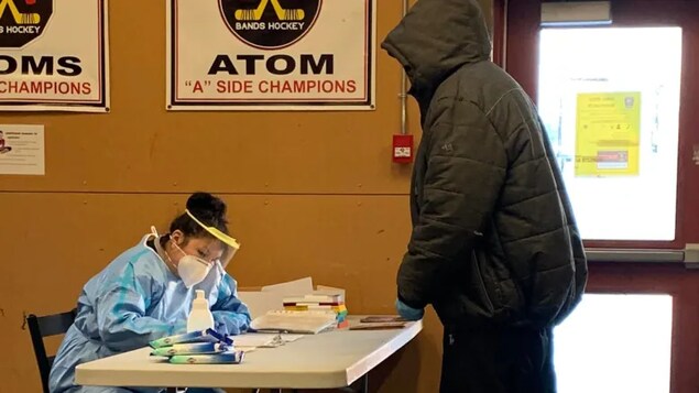 A nurse works at the arena in Bearskin Lake First Nation. The northern Ontario community of some 400 people has been overwhelmed by a COVID-19 outbreak. (Submitted by Sharon Angeconeb)