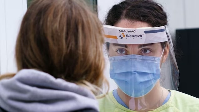 A nurse greets a woman at a walk-in clinic in Montreal. In a bid to increase the number of doctors and nurses practising in rural and remote areas, the federal government announced Tuesday it would increase forgivable loans for some students. 