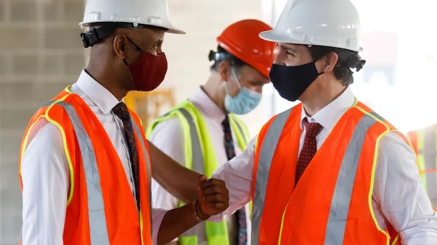 Prime Minister Justin Trudeau, right, greets Social Development Minister Ahmed Hussen as they tour an affordable housing complex under construction in Hamilton on July 20.