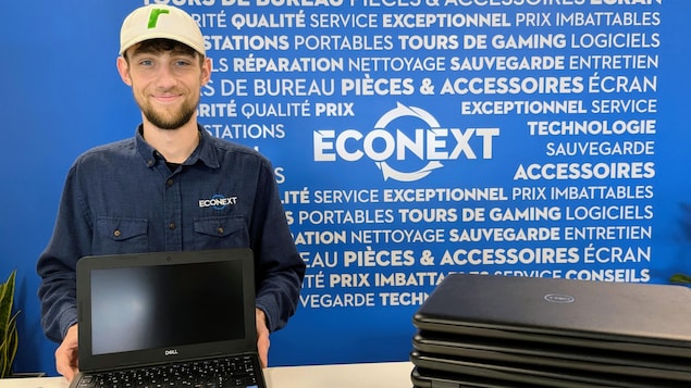 An employee and a pile of computers.