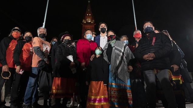 Justin Trudeau kasama ang grupo ng mga residential school survivor na nakasuot ng mask.